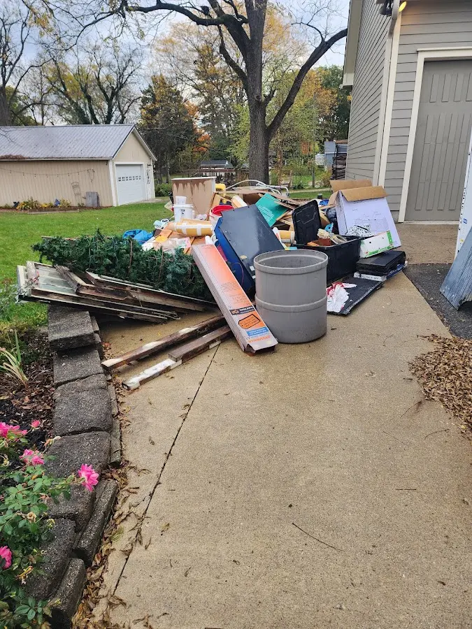 Dumpster being loaded with debris for Estate Cleanout Dumpster Rental in Punta Gorda